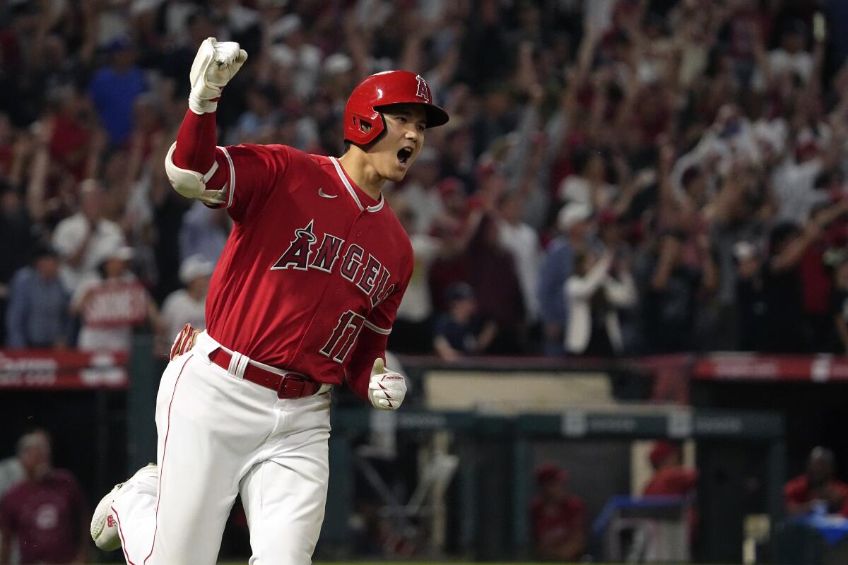 Angels' Shohei Ohtani celebrates as he rounds first after hitting a two-run home run.
