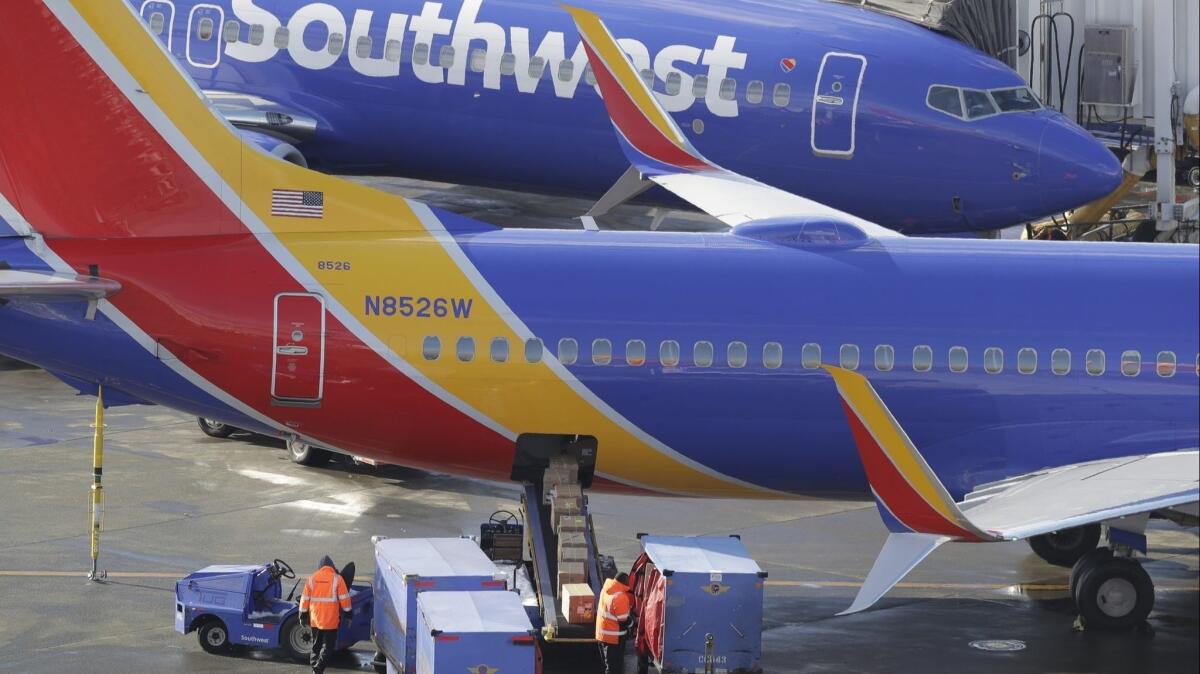 Southwest Airlines planes are loaded Tuesday at Seattle-Tacoma International Airport in Seattle.