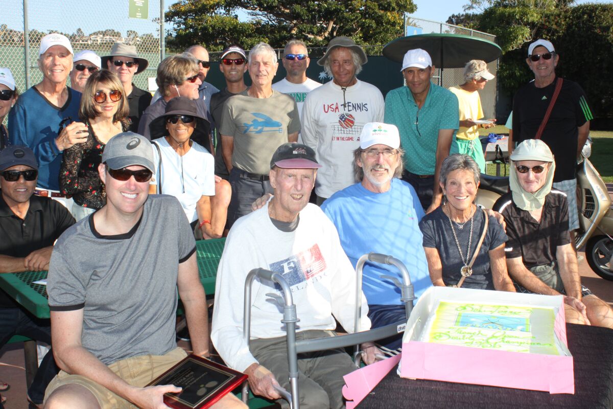 Friends and La Jolla Tennis Club members surround former tennis director Bob Perry (front, second from left), at a ceremony Oct. 5 recognizing his contribution to the Club.