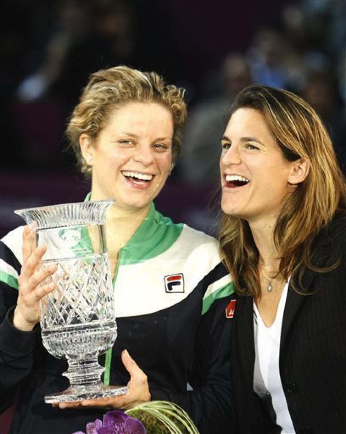 Belgium's Kim Clijsters, left, jubilates with French former tennis player Amelie Mauresmo after she won at the Paris Open tennis tournament at Coubertin stadium in Paris, Friday, Feb. 11, 2011. (AP Photo/Jacques Brinon)