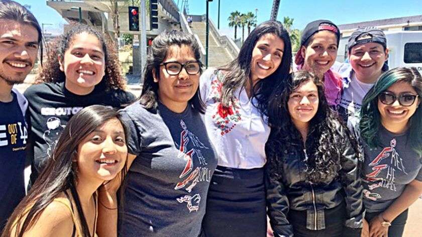 Claudia Rueda, fourth from right in black jacket, and her attorney Monika Langarica, center, after Rueda's release from the Otay Mesa Detention Center near San Diego on Friday.