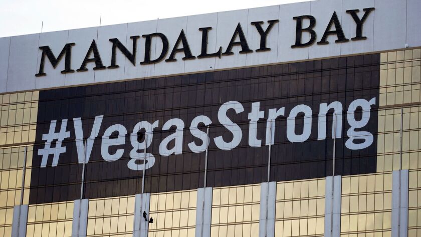 A #VegasStrong banner is displayed on the Mandalay Bay hotel and casino in Las Vegas.