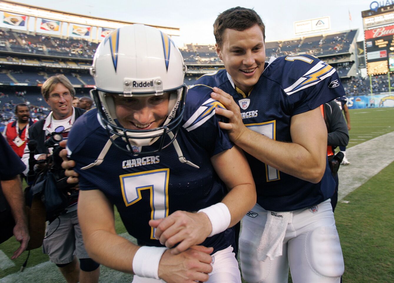 Philip Rivers and Billy Volek of the San Diego Chargers celebrate a 51-14 win against the Detroit Lions on December 16, 2007 at Qualcomm Stadium.