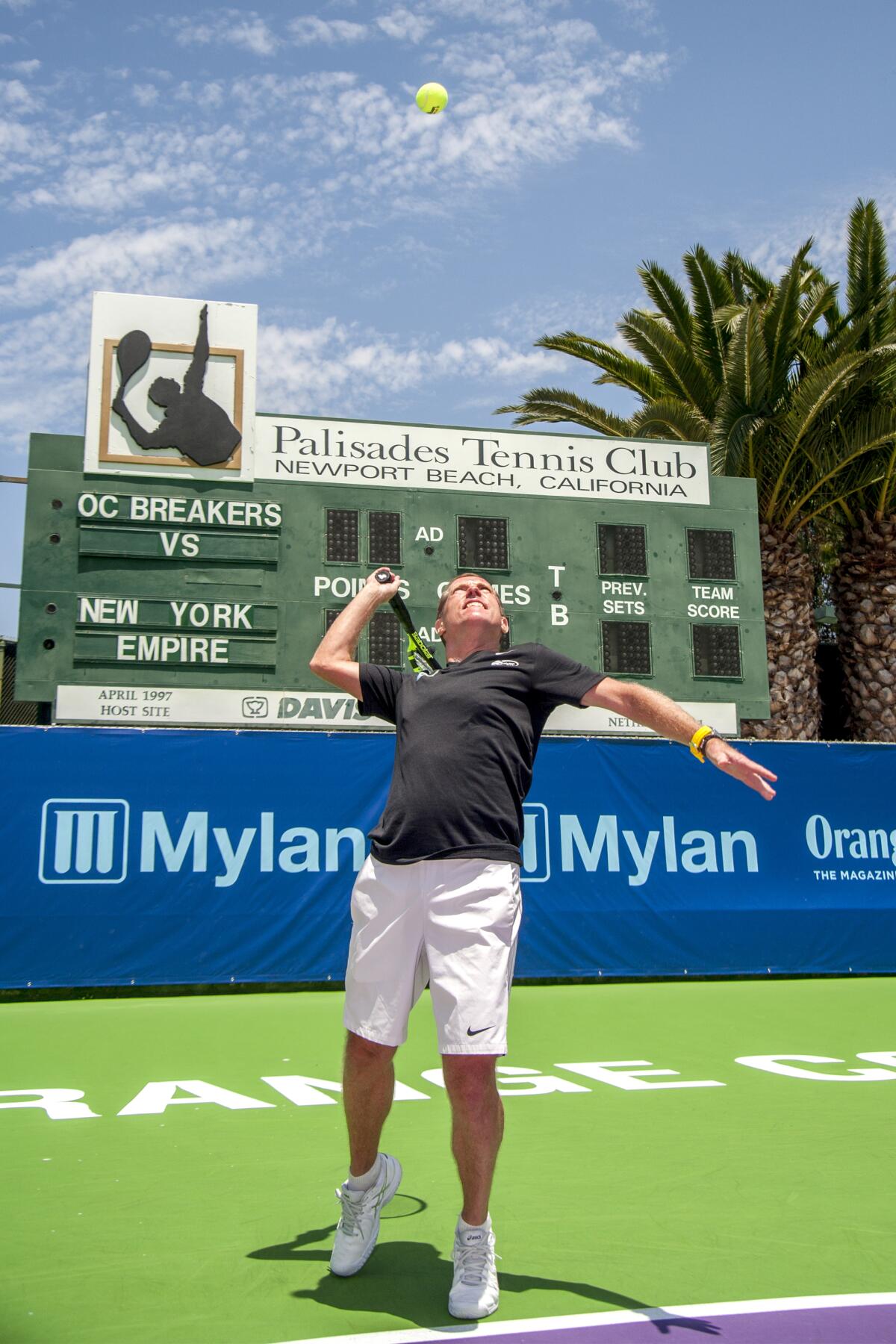 Eric Davidson, owner of the Orange County Breakers professional tennis team, serves a ball at the team's home venue, the Palisades Tennis Club in Newport Beach.