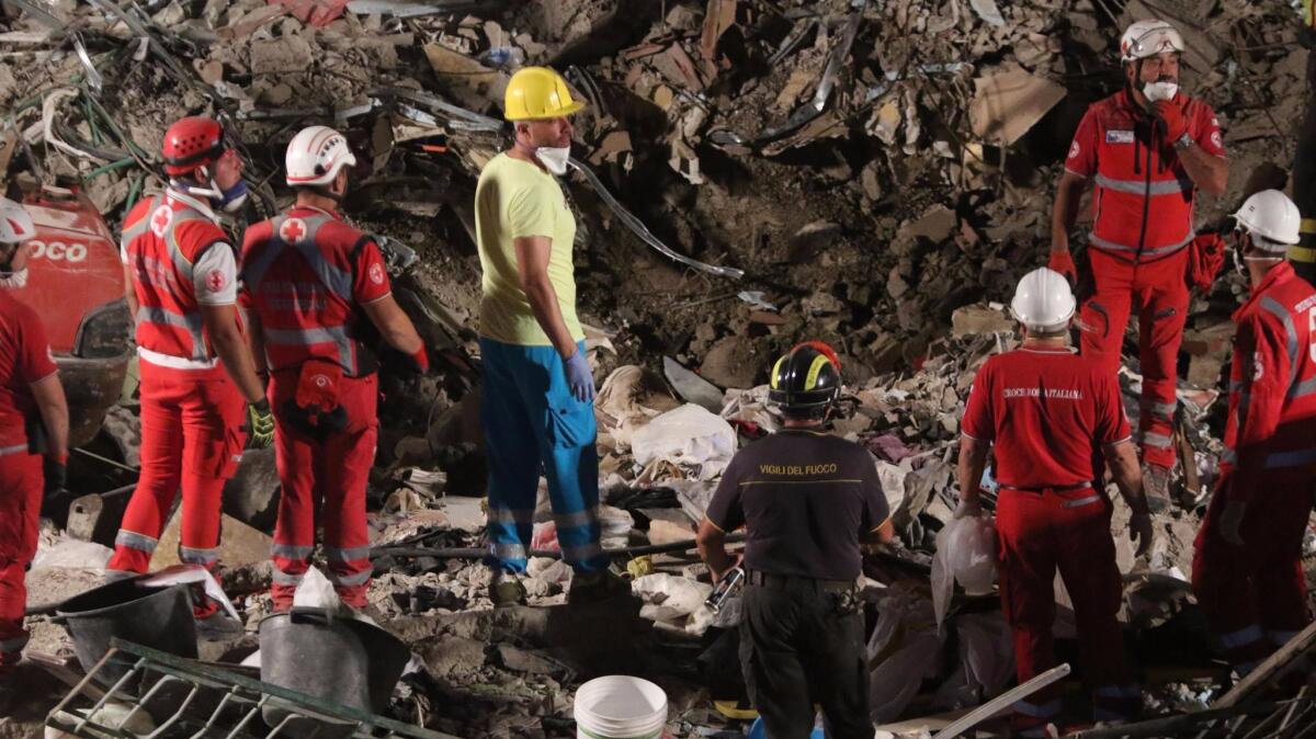 Rescuers work amid the rubble of a collapsed building in Torre Annunziata, southern Italy.