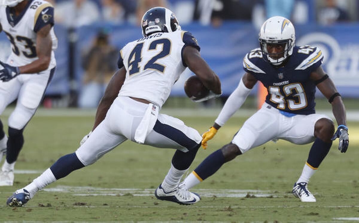 Joshua Perry of the Chargers, right, looks to take down Rams running back Justin Davis during a preseason game in 2017.