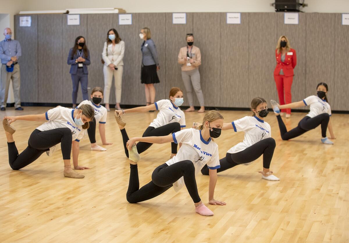Marine View Middle School students in the dance program stretch as officials take a tour of the campus on Monday.