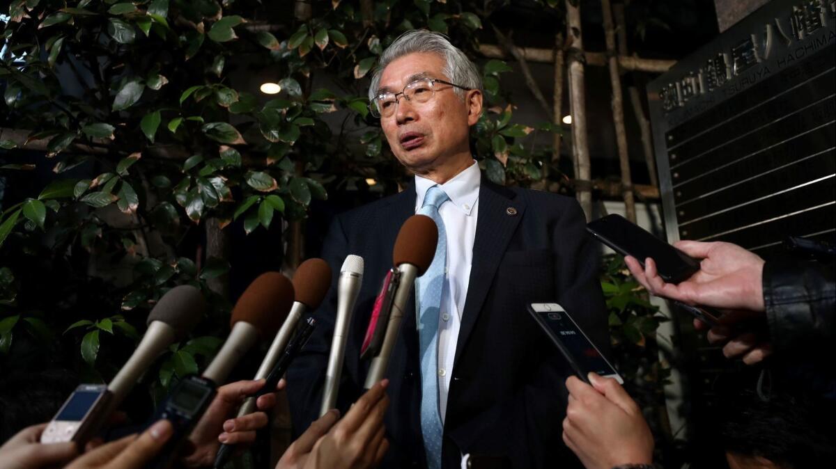Junichiro Hironaka, lawyer for former Nissan chief Carlos Ghosn, speaks with the media outside his office in Tokyo on March 11. A Japanese court barred Carlos Ghosn from attending a Nissan board meeting.