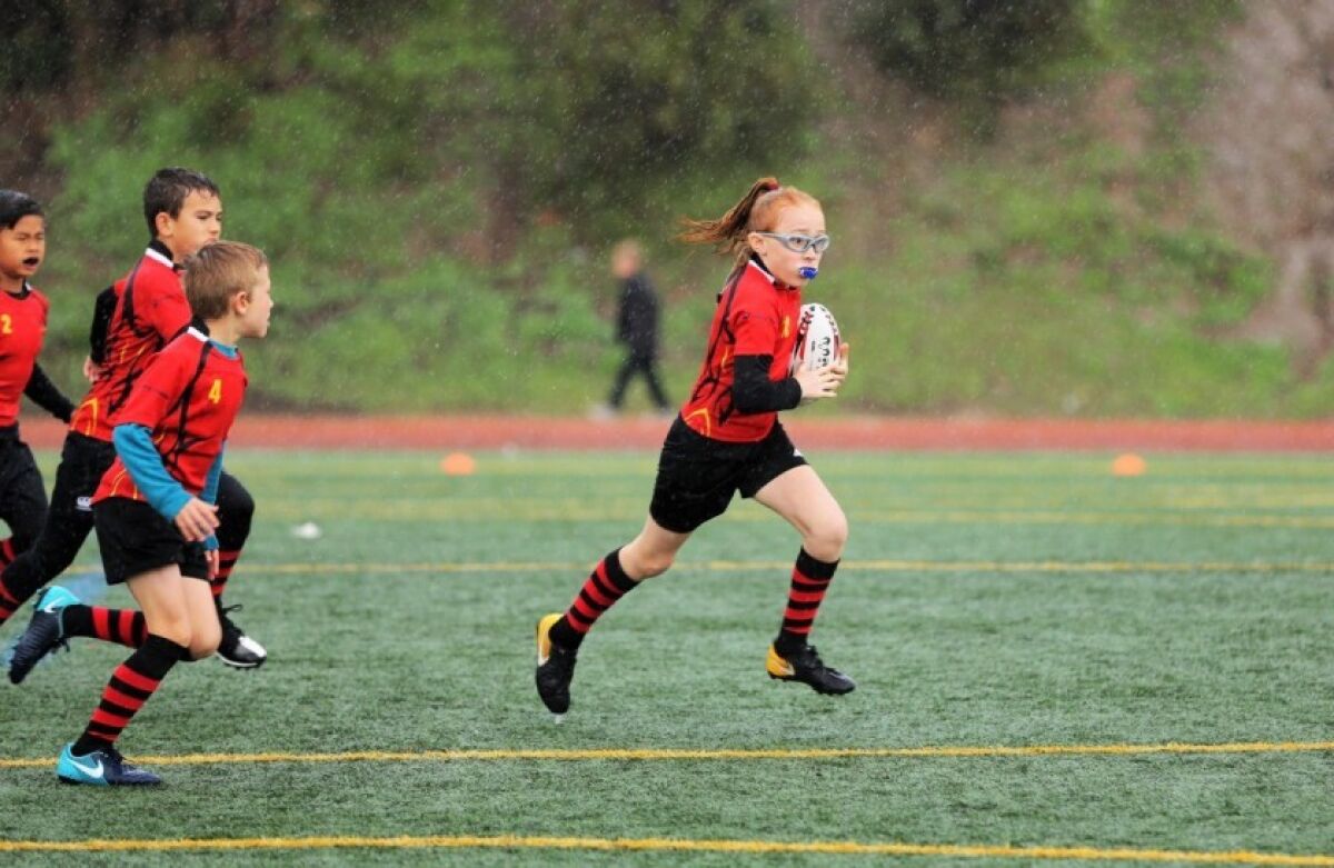 Rugby players in action on the field.