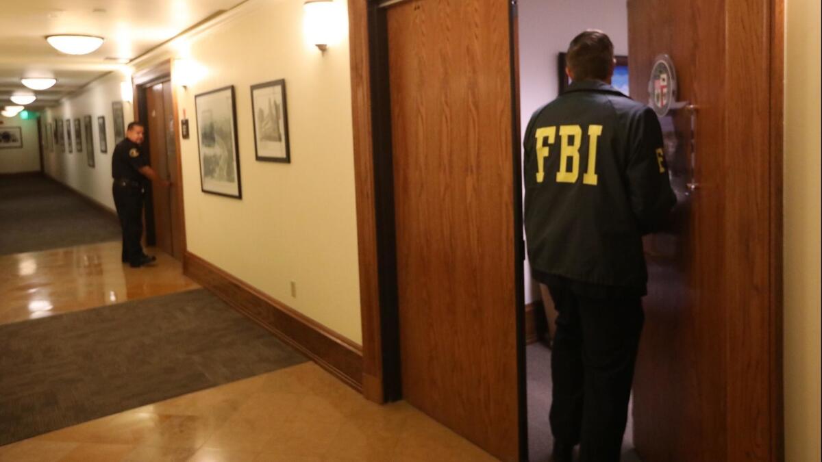 A FBI agent enters the office of City Councilman Jose Huizar at Los Angeles City Hall on November 7, 2018.