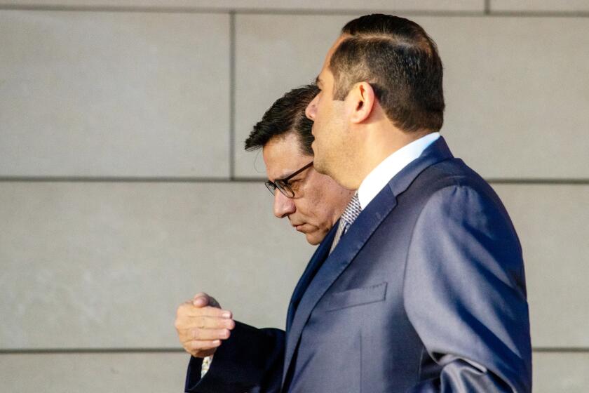 LOS ANGELES CA JANUARY 20, 2023 - Former Los Angeles City Councilman Jose Huizar, left, arrives at the Federal Courthouse on Los Angeles Friday, January 20, 2023, where he is expected to plead guilty to two federal charges stemming from a City Hall-based bribery and money laundering scheme in which he took more than $1.5 million in cash, gambling trips and escorts in exchange for his support of a planned downtown hotel project.