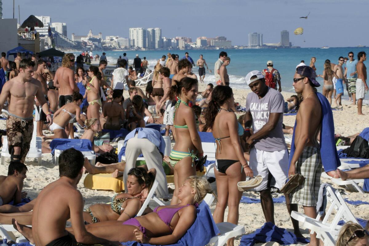 Spring-breakers at the beach in the resort city of Cancun, Mexico, in 2009.
