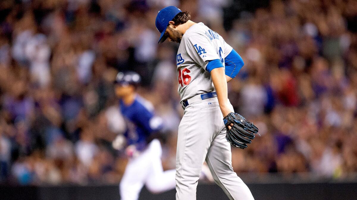 Dodgers starter Mike Bolsinger waits for Rockies slugger Carlos Gonzalez to round the bases after giving up one of three home runs in the fourth inning Friday night in Denver.