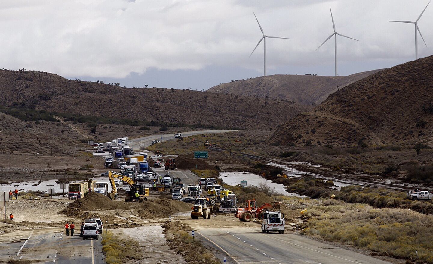 Big-rigs sit stranded on California 58 as cleanup operations are underway in the Tehachapi area.