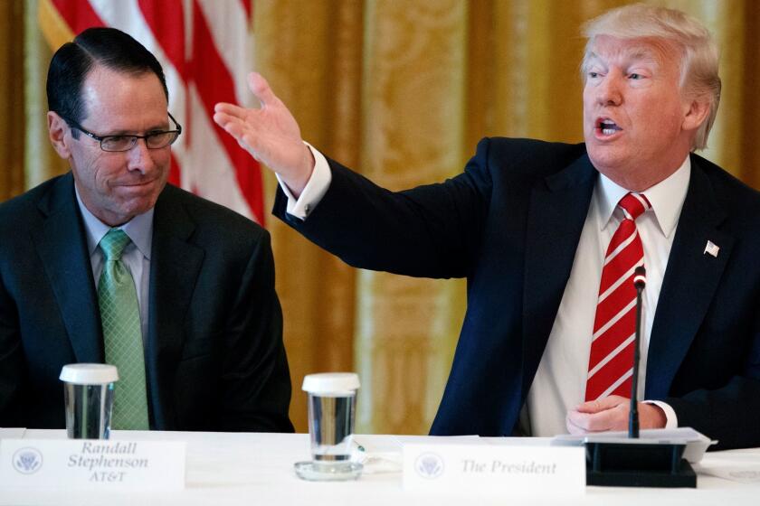 AT&T CEO Randall Stephenson, left, looks on as President Donald Trump speaks during the "American Leadership in Emerging Technology" event in the East Room of the White House, Thursday, June 22, 2017, in Washington. (AP Photo/Evan Vucci)