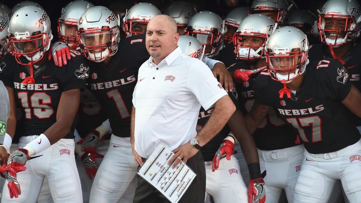 Coach Tony Sanchez and the UNLV players prepare to take the field before their game against Howard on Sept. 2.
