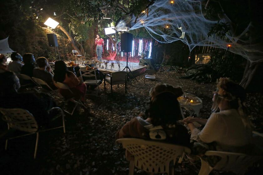 LOS ANGELES, CALIF. - OCT. 28, 2022. Little Secret presents a Halloween costume comedy event in the backyard of a house in Hollywood on Friday night, Oct. 28, 2022. The underground world of stand-up comedy house shows features the people in the L.A. comedy scene on stages in garages and backyards from the San Fernando Valley to the Hollywood Hills. (Luis Sinco / Los Angeles Times)