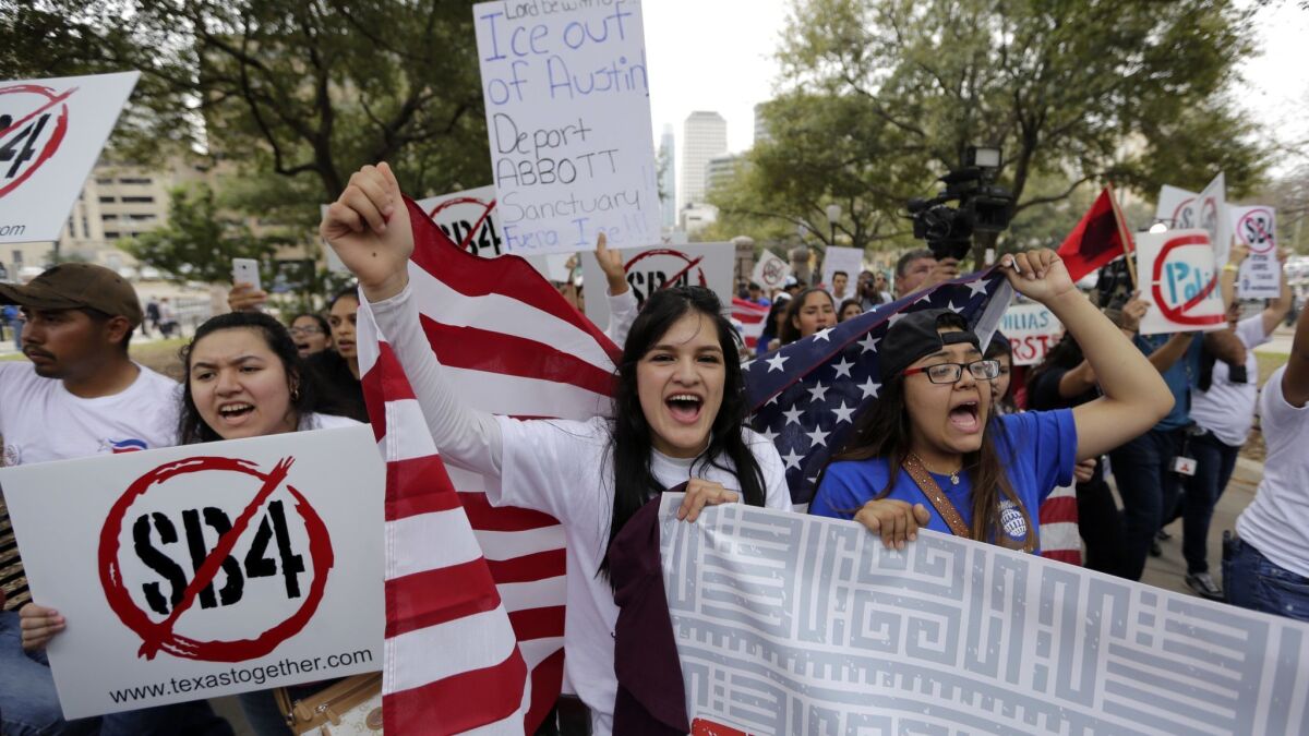 Protesters demonstrate outside the Texas Capitol in Austin against SB 4, an immigration bill, in 2017. A federal appeals court upheld most portions of the bill Tuesday.