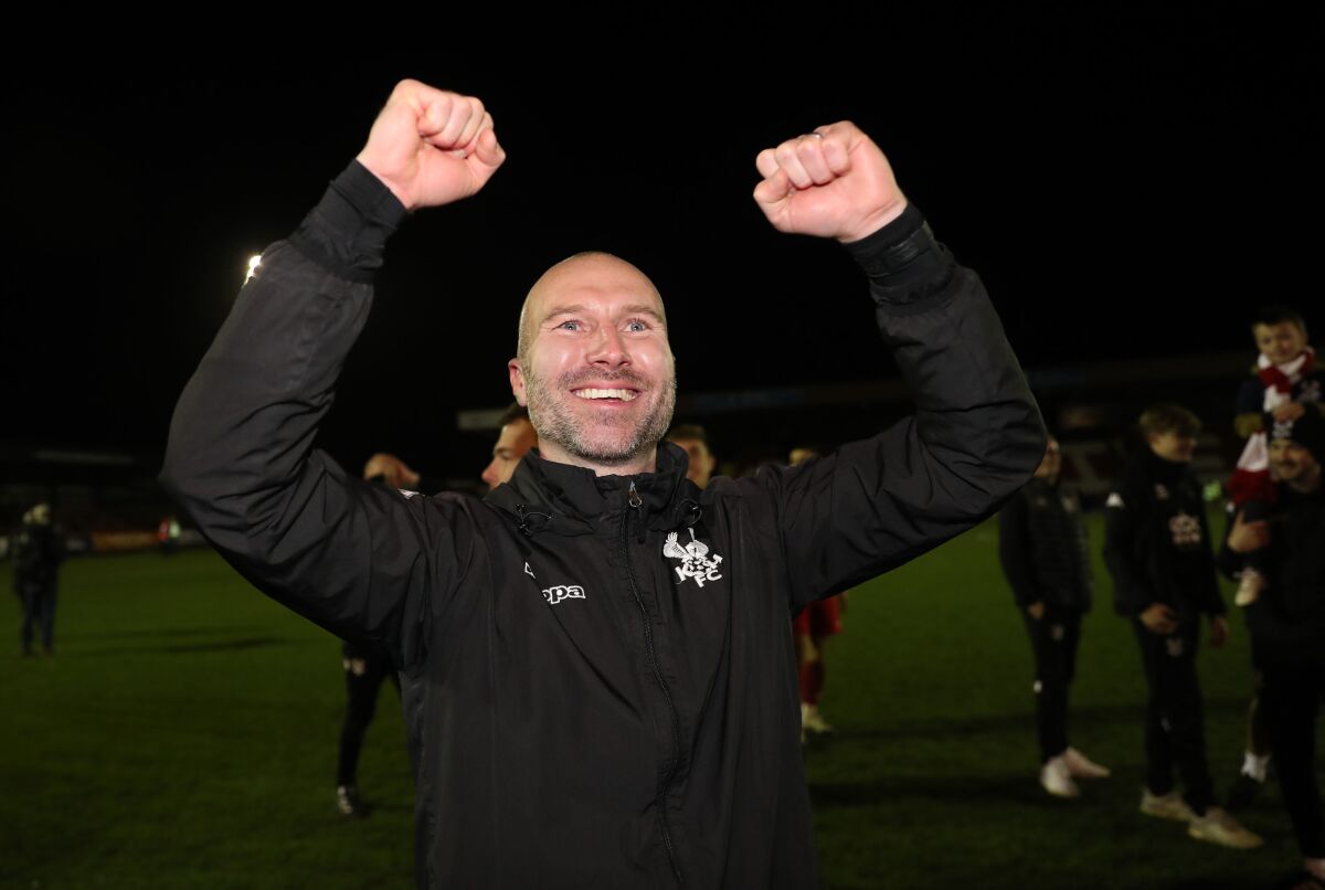 FILE - Kidderminster Harriers' manager Russ Penn celebrates after they won their FA Cup match against Reading, in Kidderminster, England, Jan. 8, 2022. Premier League team West Ham is heading to sixth-tier Kidderminster Harriers for a fourth-round game in the FA Cup between clubs separated by 113 places on English soccer’s pyramid. The last time the Harriers enjoyed such a memorable cup run came in 1994 when they were eliminated in the fifth round by West Ham. Kidderminster manager Russ Penn says “I just hope I can write a little bit of history, so that people say, ’Remember that squad, remember that team, remember that cup run.'” (Bradley Collyer/PA via AP, file)