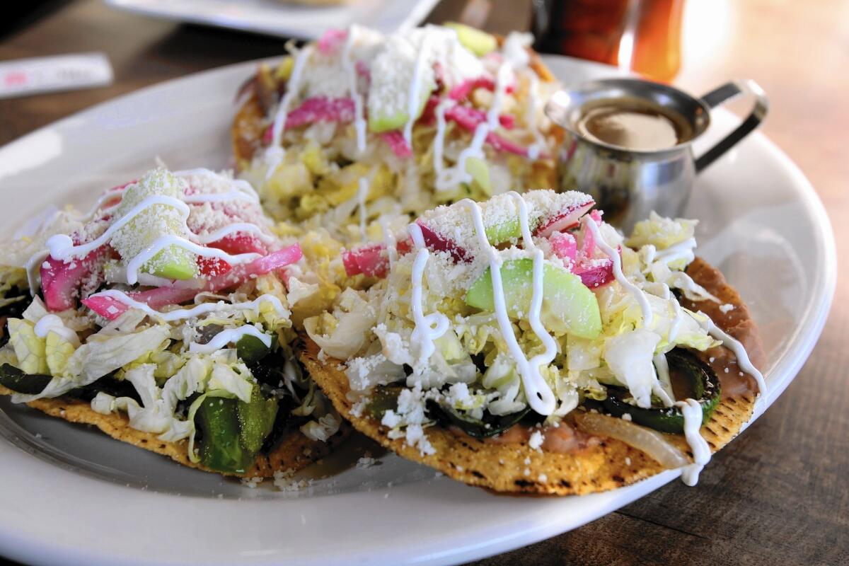 The veggie tostadas come with tomato, bell pepper, red and white onions, cucumbers, Cotija cheese and Mexican sour cream at Cafe de Olla in Burbank.
