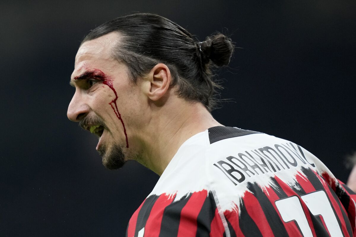 AC Milan's Zlatan Ibrahimovic reacts after an injury from a header during the Serie A soccer match between AC Milan and Bologna at the San Siro stadium, in Milan, Italy, Monday, April 4, 2022. (AP Photo/Antonio Calanni)