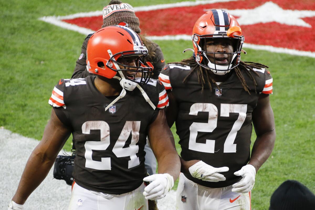 FILE - Cleveland Browns running backs Nick Chubb (24) and Kareem Hunt (27) walk off the field after the Browns defeated the Houston Texans in Cleveland, Nov. 15, 2020. The Browns weren’t able to use the Chubb-Hunt tandem much last season due to injuries. But coach Kevin Stefanki knows the duo poses unique threats to opposing defenses and could lean on it more this year. (AP Photo/Ron Schwane, File)