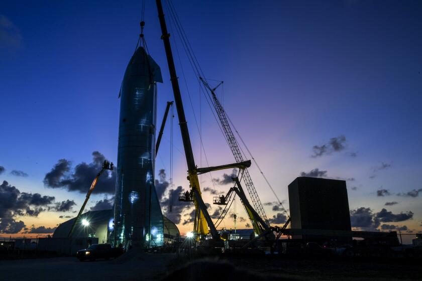 BROWNSVILLE, TX - SEPTEMBER 27: Workers put the finishing touches on a prototype of a spaceship called Starship before SpaceX CEO Elon Musk arrives to update the progress on the project. (Photo by Jonathan Newton / The Washington Post via Getty Images)