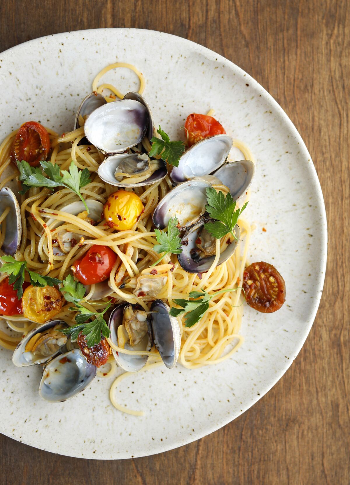 Spaghetti alle Vongole, a classic Neapolitan Christmas dish, includes fresh spaghetti with Manila clams.