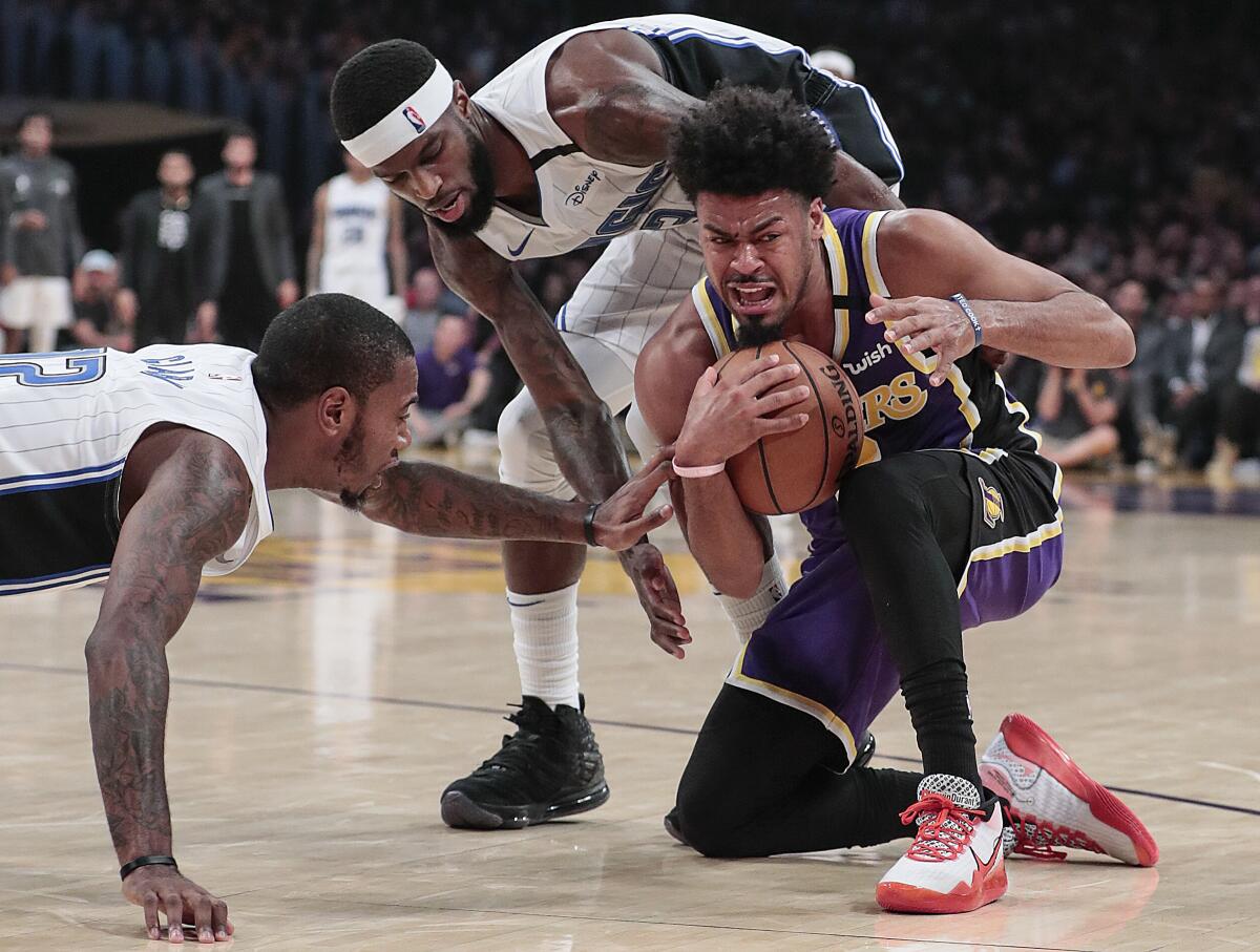 Lakers guard Quinn Cook grabs a loose ball against Orlando.