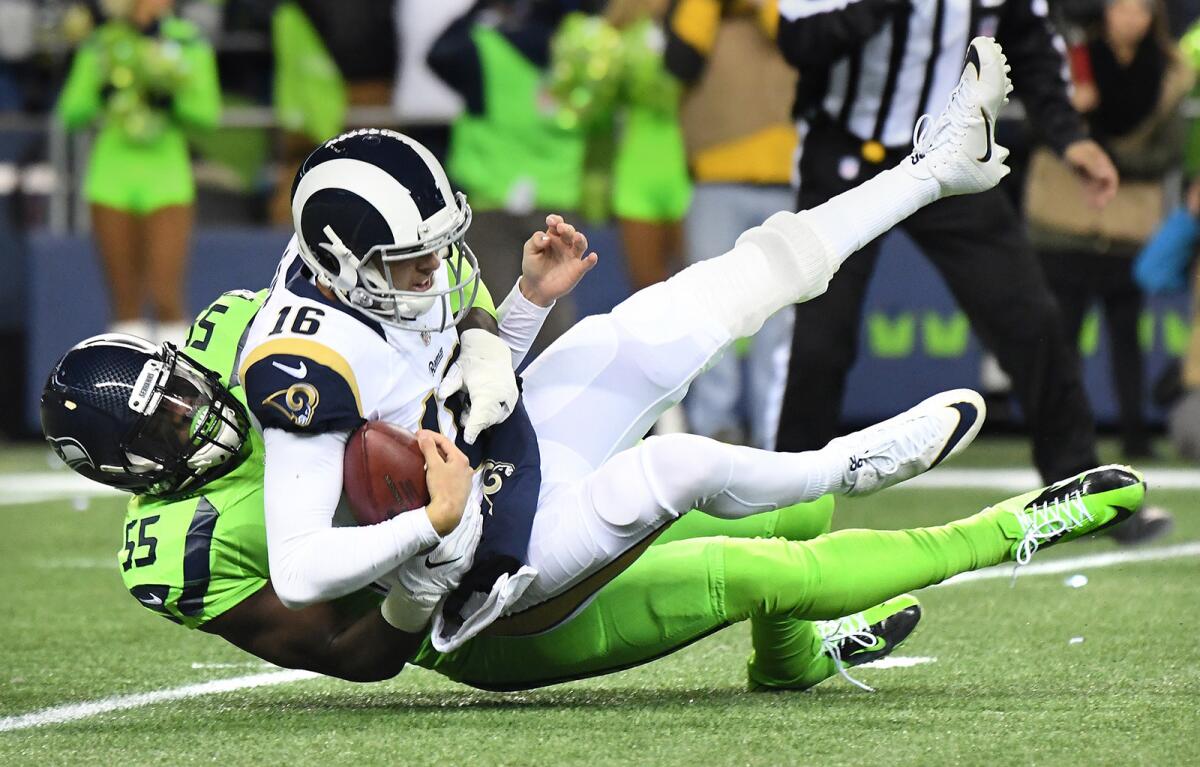 Rams quarterback Jared Goff is sacked by Seahawks defensive end Frank Clark during the first quarter of a game at CenturyLink Field on Dec. 15.