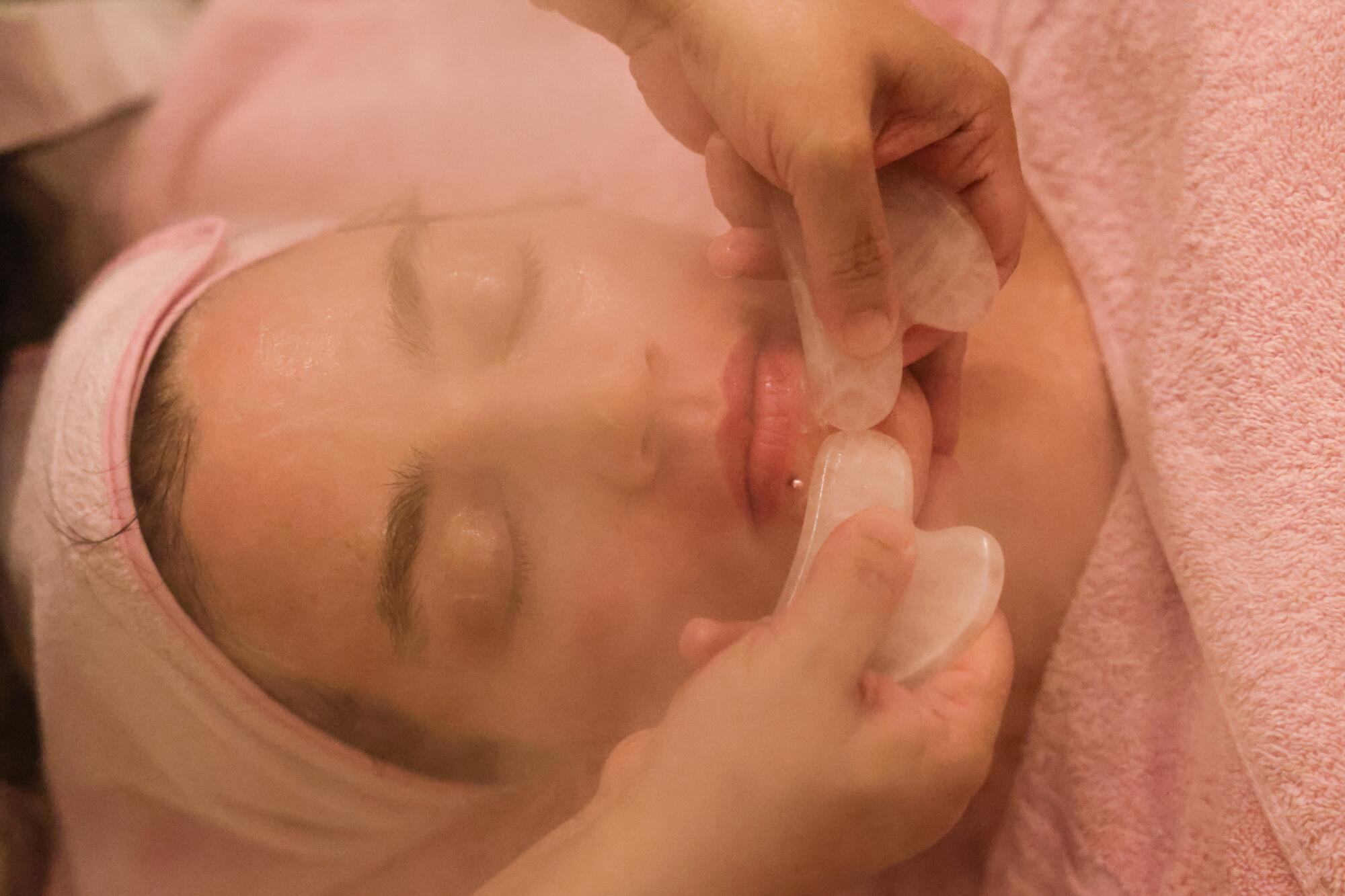 A woman getting a facial.