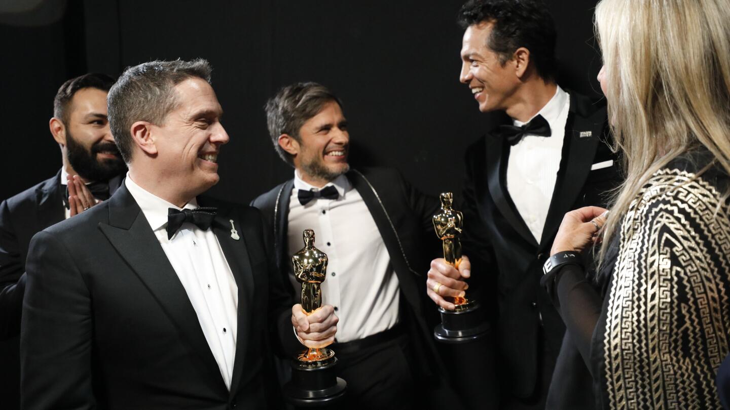 Adrian Molina, left, Lee Unkrich, Gael Garcia Bernal, Benjamin Bratt and Darla K. Anderson from "Coco" backstage at the 90th Academy Awards on Sunday.