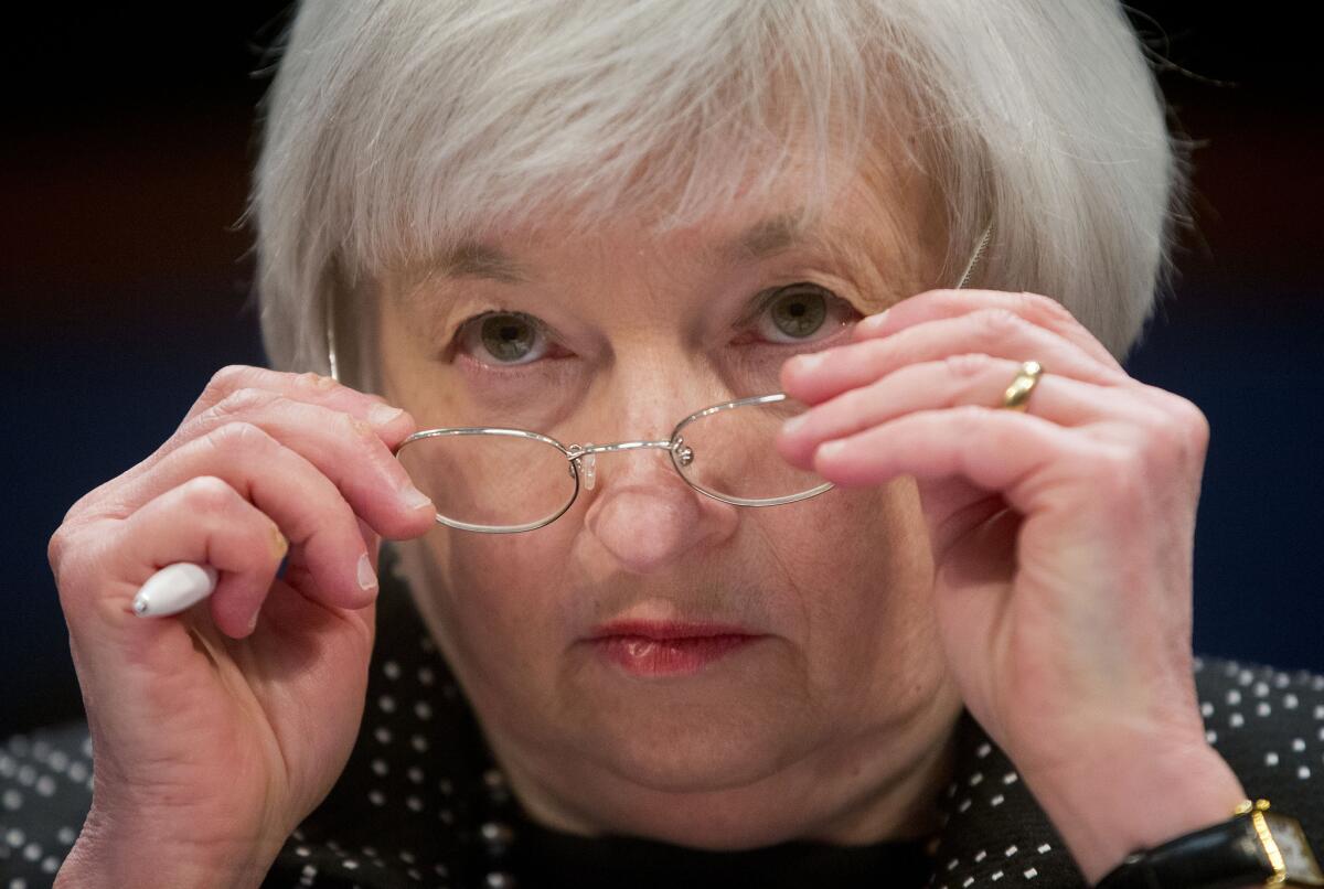 Federal Reserve Chairwoman Janet L. Yellen removes her glasses as she testifies on Capitol Hill on Feb. 25.
