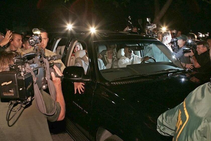An SUV carrying Paris Hilton and family is escorted by Sheriff deputies as it makes its way out of the parking lot at Los Angeles County Jail in Lynwood. Hilton was released about 15 minutes after midnight Tuesday, marking the official end to her 23-day jail stay for violating probation on an alcohol-related reckless driving conviction.
