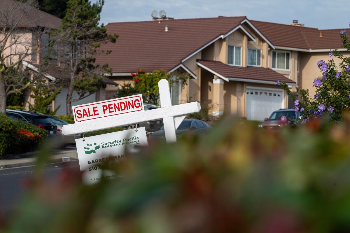 A "Sale Pending" sign in front of a home 