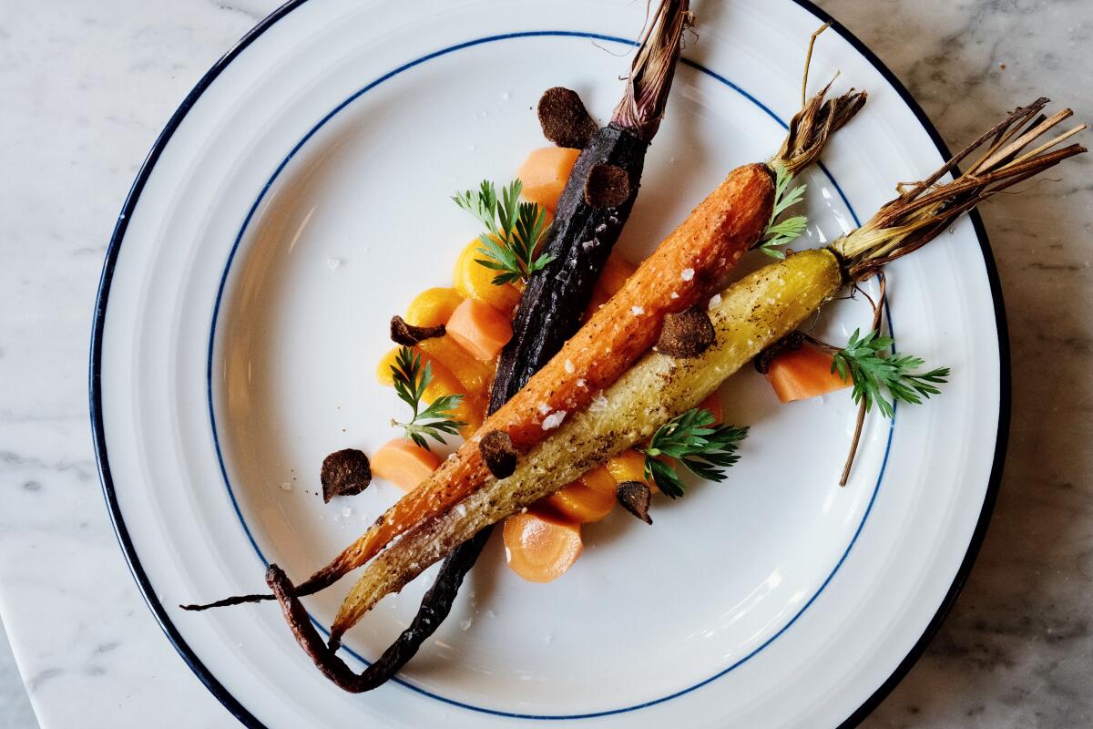 Four -way carrots (roasted, puree, pickled and crispy) in a time plate in Bumvons Wine Bar + Restaurant in Long Beach.