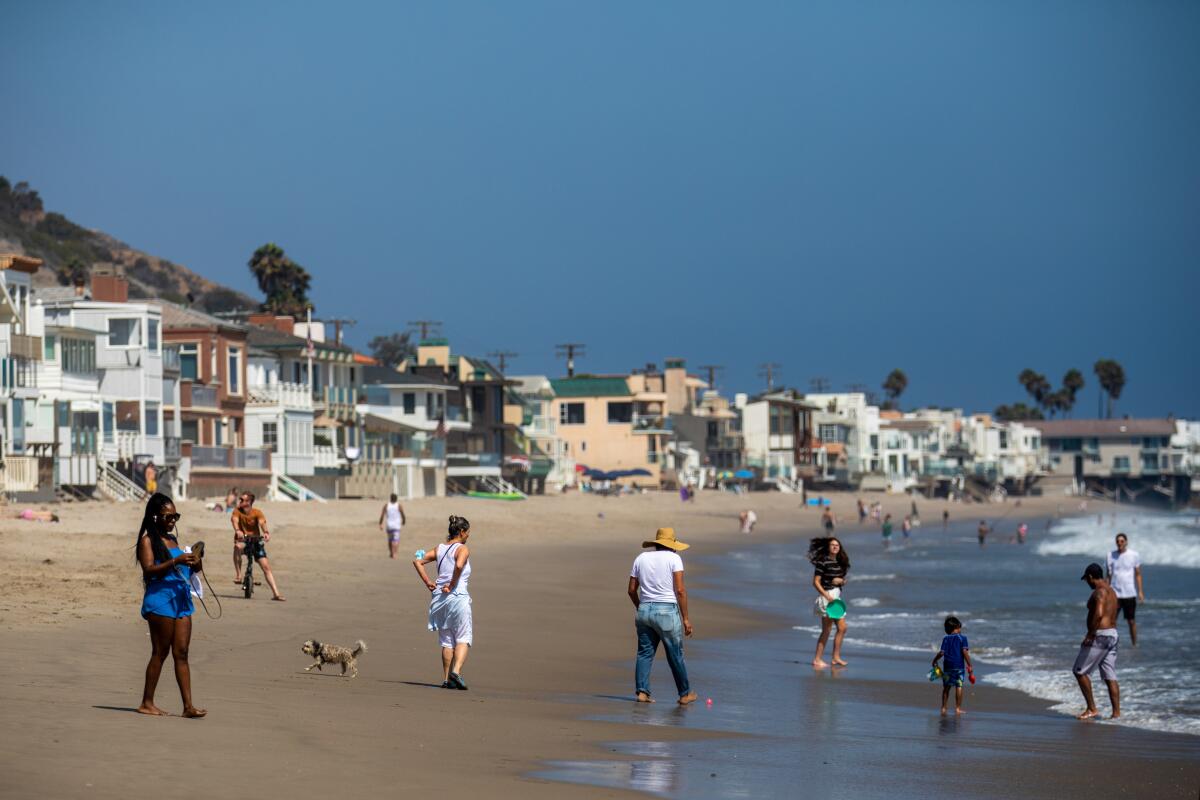 :Beach goers enjoying La Costa Beach on Sunday, Aug. 8, 2021 in Malibu, CA. 