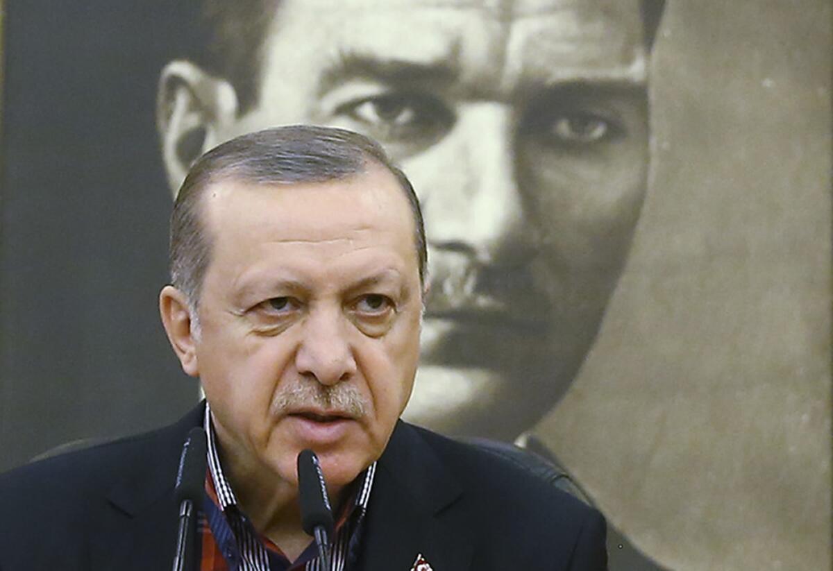 Turkish President Recep Tayyip Erdogan, shown before a portrait of Turkey's founding father, Kemal Ataturk.