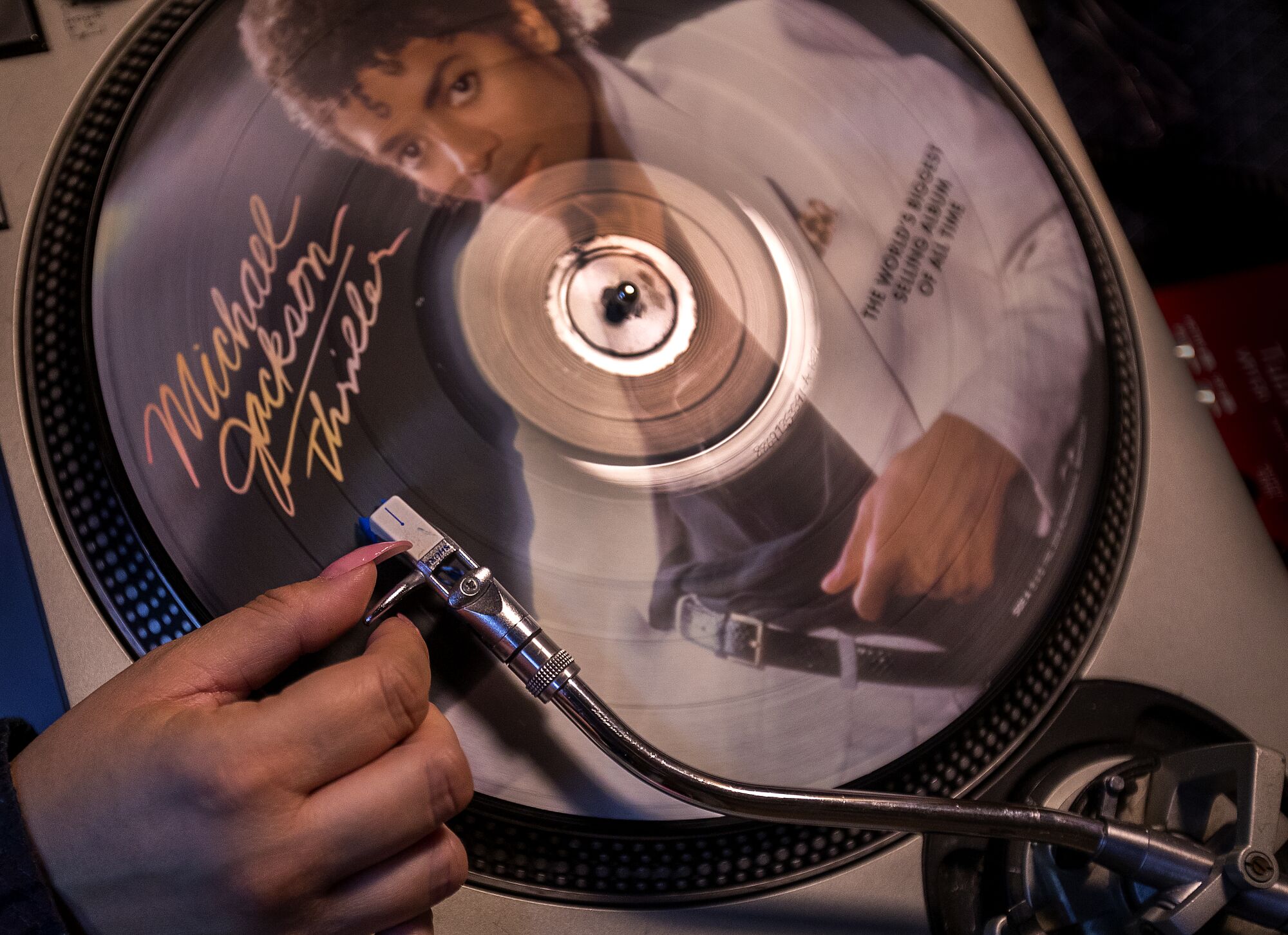 Melissa Magallanes listens to a Michael Jackson "Thriller" record for quality control after it is pressed.