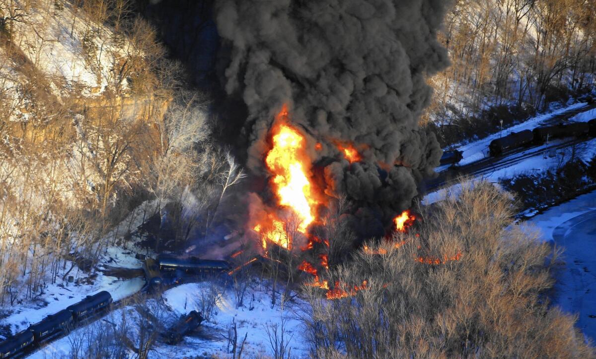 Flames erupt from a train that derailed March 4 near Galena, Ill., spilling crude oil near the intersection of the Mississippi and Galena rivers.