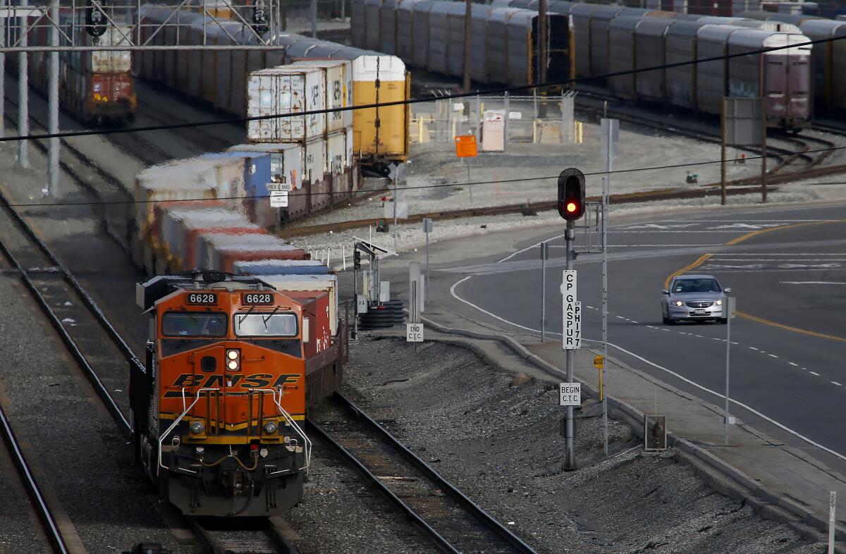 A diesel locomotive hauls cargo from the Port of Long Beach