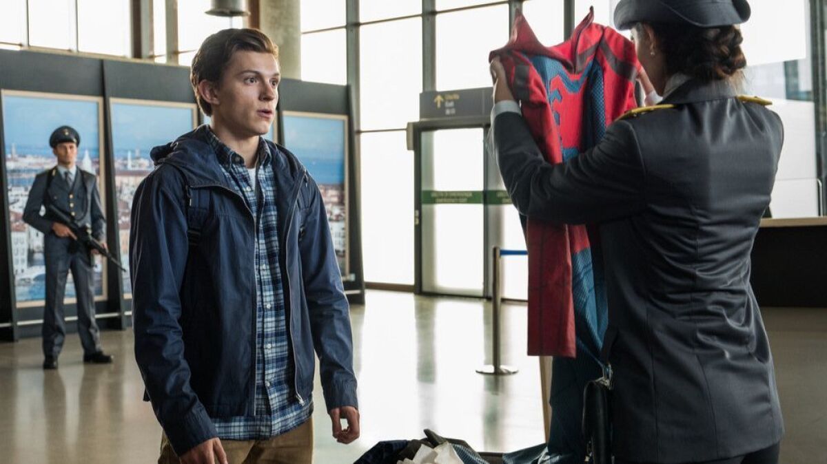 Peter Parker (Tom Holland) is stopped by an Italian customs officer (Giada Benedetti) in Sony Pictures’ “Spider-Man: Far From Home.” The film brings the first three phases of the Marvel Cinematic Universe to a close and concludes the decade-spanning Infinity Saga.
