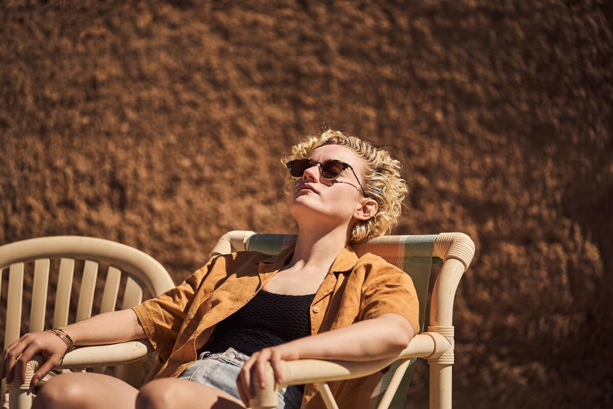 A woman in shades suntans.