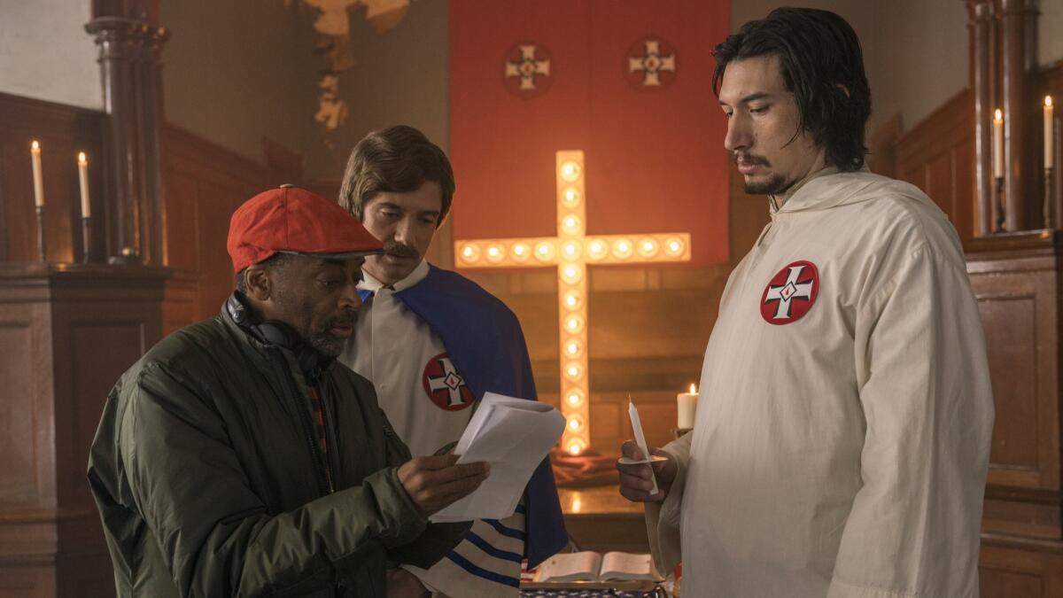 Spike Lee, left, with actors Topher Grace, center, and Adam Driver on the set of Lee's film "BlacKkKlansman."
