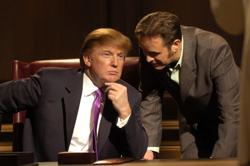 Donald Trump and Mark Burnett confer during a boardroom scene in the first season of "The Apprentice," shot in 2004.