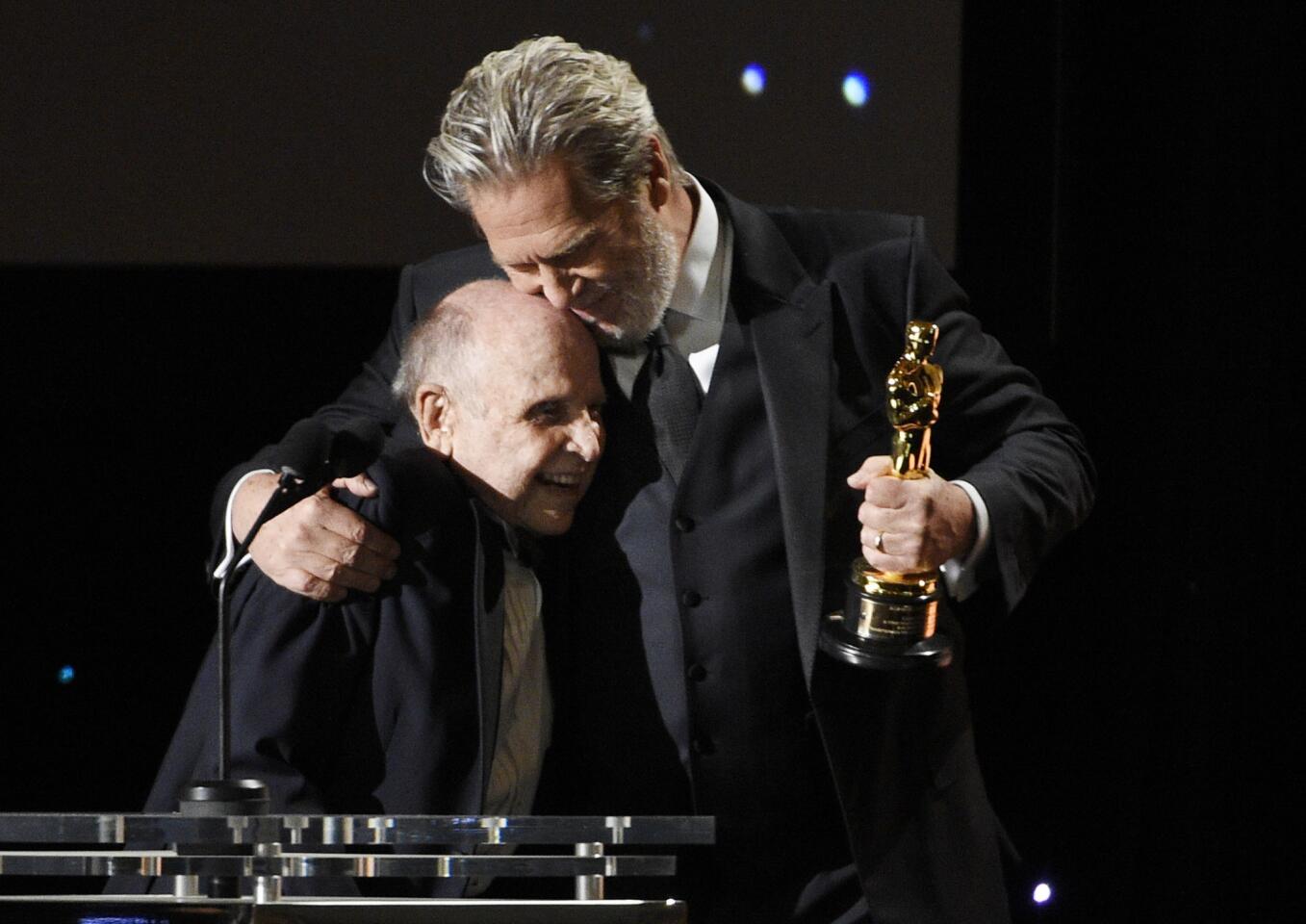 Honoree Lynn Stalmaster, left, is embraced by presenter Jeff Bridges at the film academy's 2016 Governors Awards at the Dolby Ballroom on Saturday.