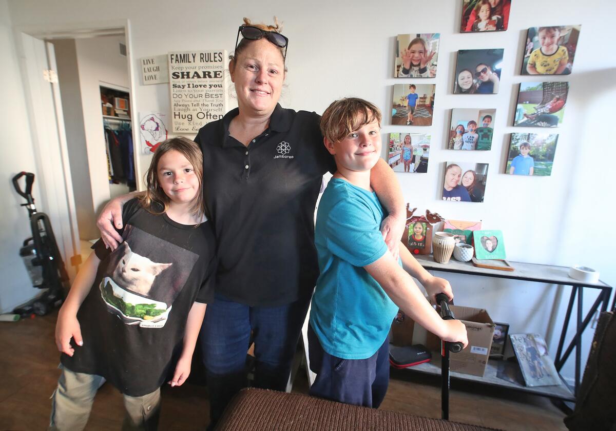 Allison Cuff with her kids Lexy and Nathan, from left, in their apartment in Huntington Beach. 