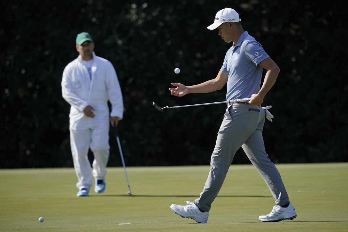 Collin Morikawa catches his ball after putting on the fifth hole during a practice round for the Masters golf tournament on Monday, April 4, 2022, in Augusta, Ga. (AP Photo/Robert F. Bukaty)