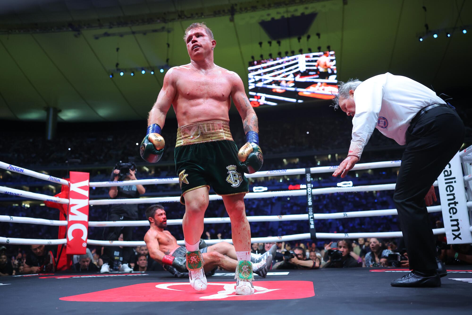 Canelo ?lvarez reacts reacts as John Ryder lies on the canvas during their fight in Mexico Saturday