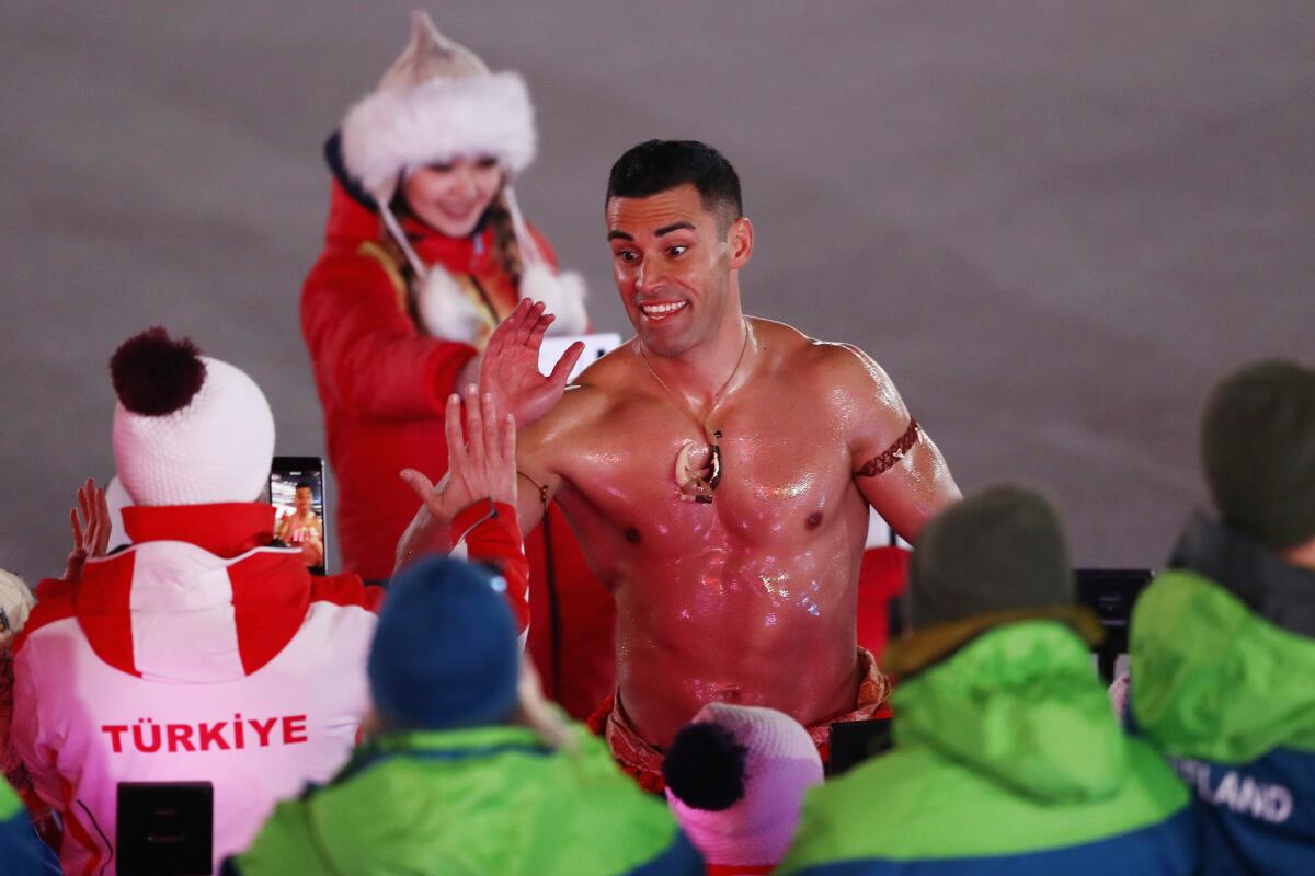 Taufatofua greets fans during the Winter Olympics opening ceremony on Feb. 9.